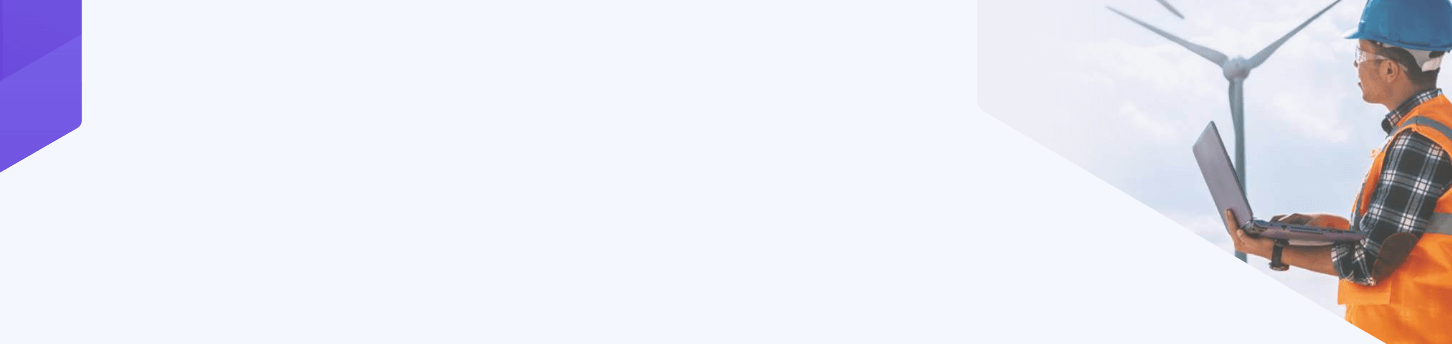 engineer working with a laptop and looking at a renewable energy wind turbine